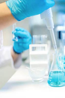 Laboratory equipment and beaker with blue liquid